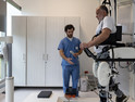 robot holds senior patient's weight during physical therapy