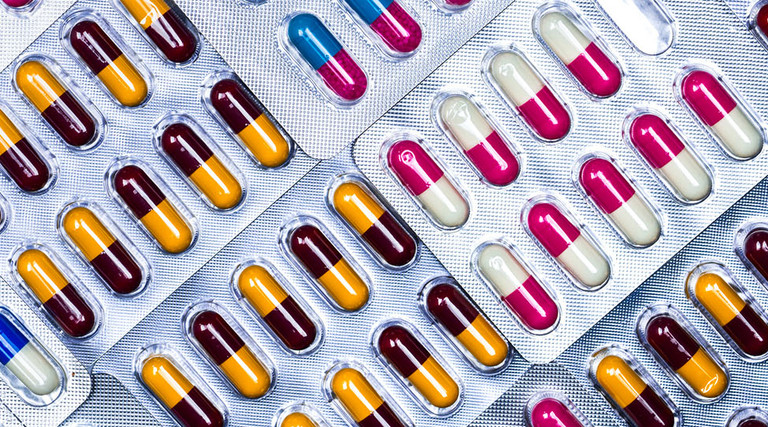 Full frame of colorful antimicrobial capsule pills.